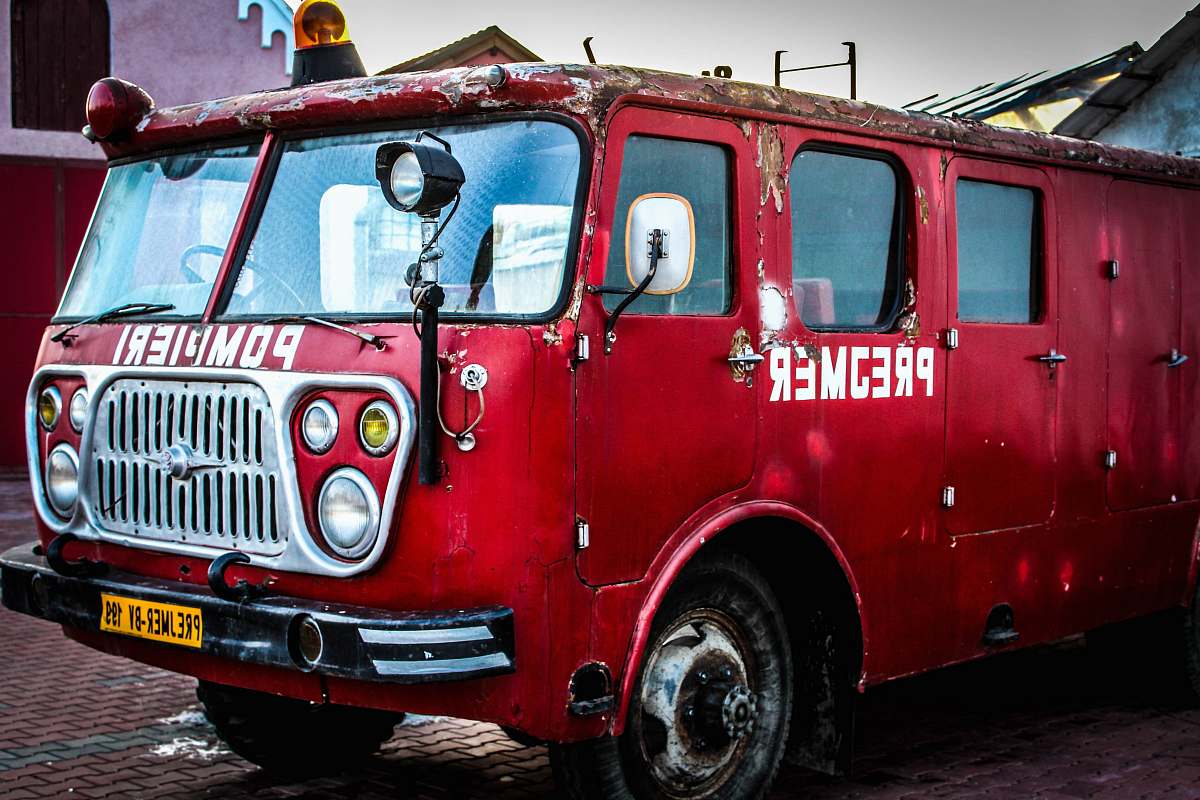 vehicle red car on parking lot truck